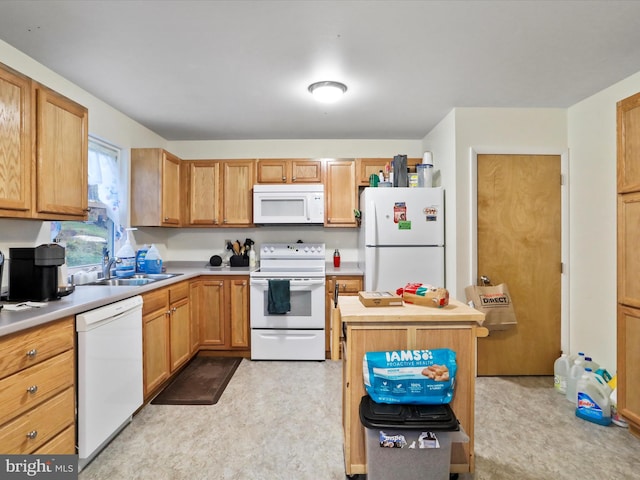 kitchen with light colored carpet, white appliances, and sink