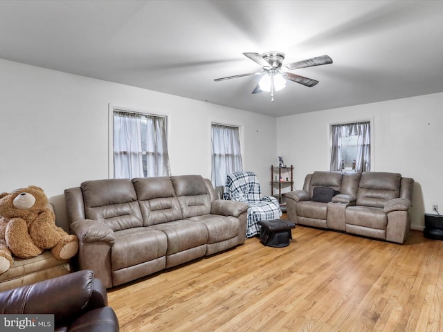 living room with light hardwood / wood-style floors, plenty of natural light, and ceiling fan