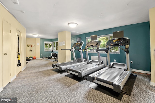 exercise room with carpet floors and a healthy amount of sunlight