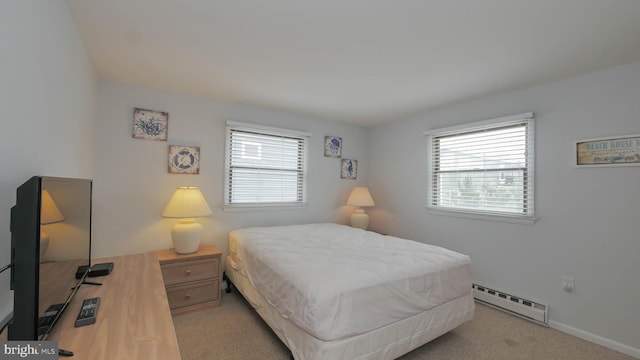 bedroom featuring light carpet, multiple windows, and a baseboard heating unit