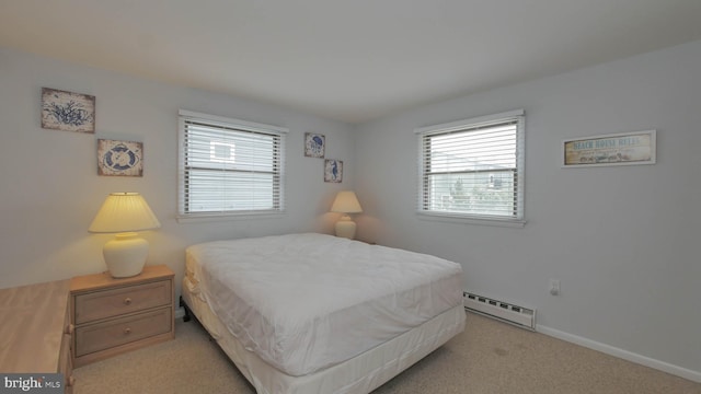 bedroom with multiple windows, light carpet, and a baseboard radiator