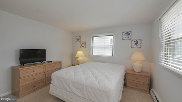 bedroom featuring light colored carpet and a baseboard radiator