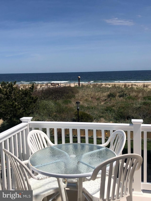 balcony with a view of the beach and a water view