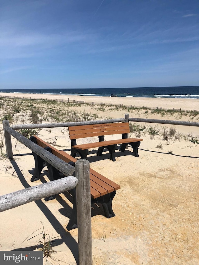 view of property's community featuring a water view and a view of the beach