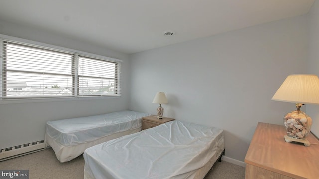 carpeted bedroom featuring a baseboard radiator