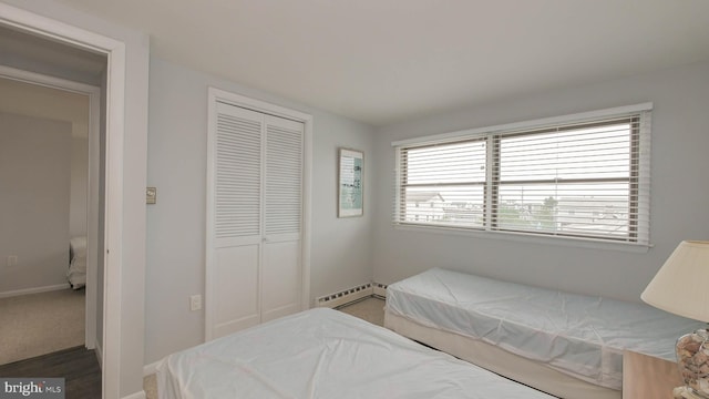 bedroom with a closet and a baseboard radiator