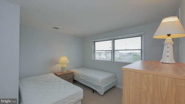 bedroom featuring light colored carpet