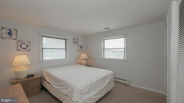 carpeted bedroom featuring a baseboard radiator