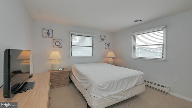 bedroom featuring light colored carpet, multiple windows, and a baseboard radiator