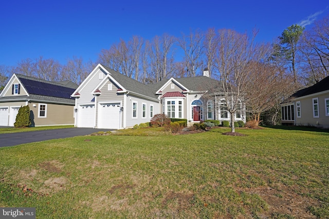 view of front of property featuring a garage and a front lawn