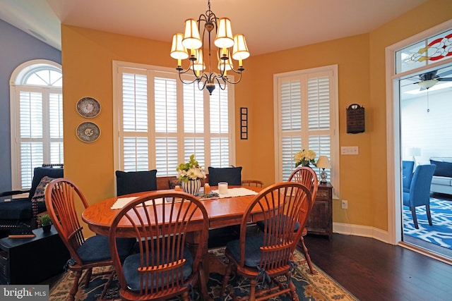 dining area with dark hardwood / wood-style floors and ceiling fan with notable chandelier