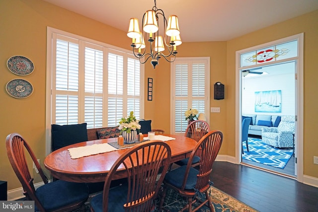 dining area featuring dark hardwood / wood-style flooring and a notable chandelier