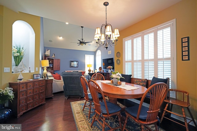 dining space featuring dark wood-type flooring and ceiling fan with notable chandelier