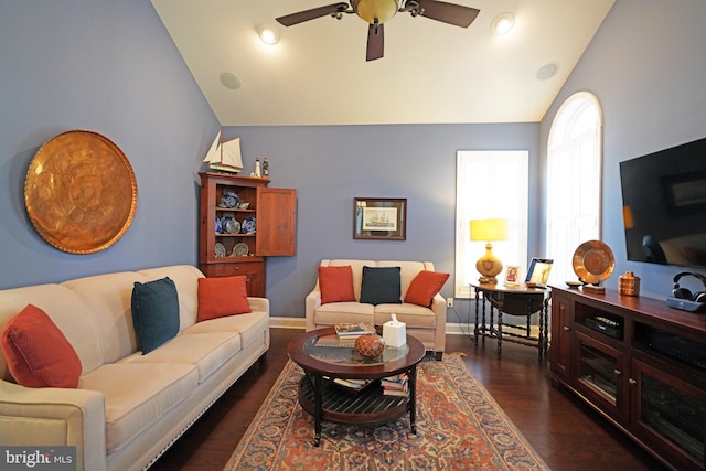 living room with ceiling fan, lofted ceiling, and dark wood-type flooring