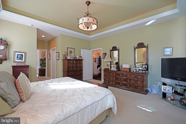 bedroom featuring crown molding, light carpet, a tray ceiling, and a chandelier