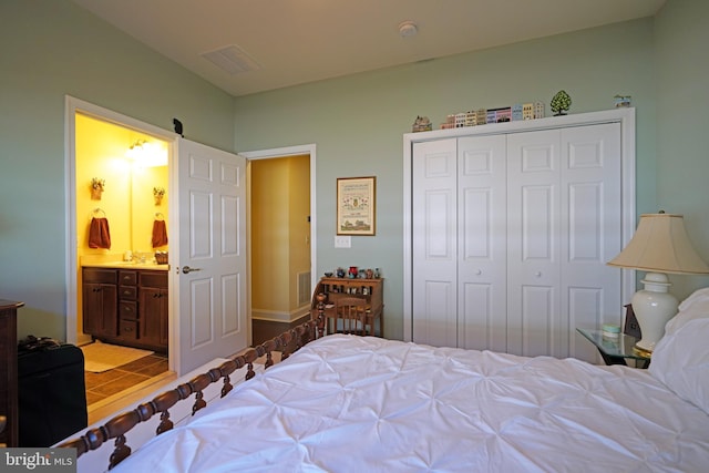 bedroom with ensuite bath and a closet