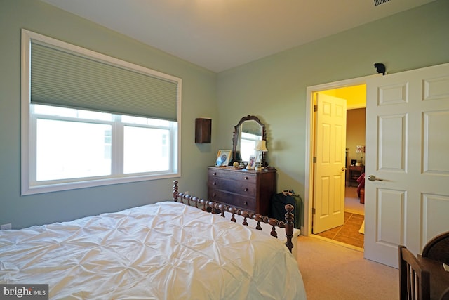 bedroom featuring light colored carpet