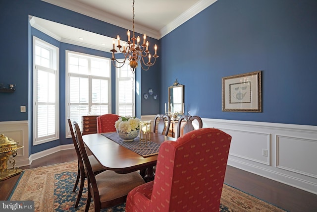 dining space with dark hardwood / wood-style flooring, crown molding, and plenty of natural light