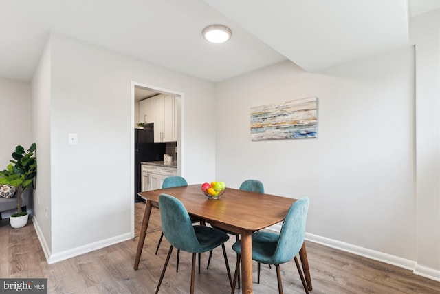 dining space with light hardwood / wood-style floors