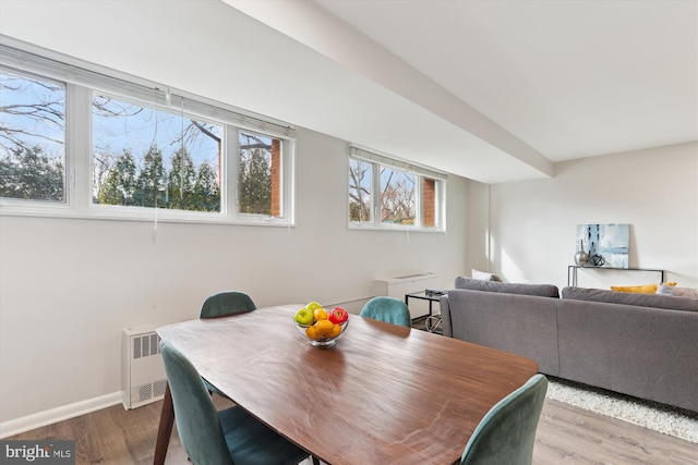 dining room featuring light wood-type flooring and radiator heating unit