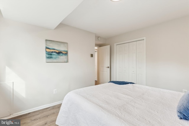 bedroom featuring light hardwood / wood-style floors and a closet