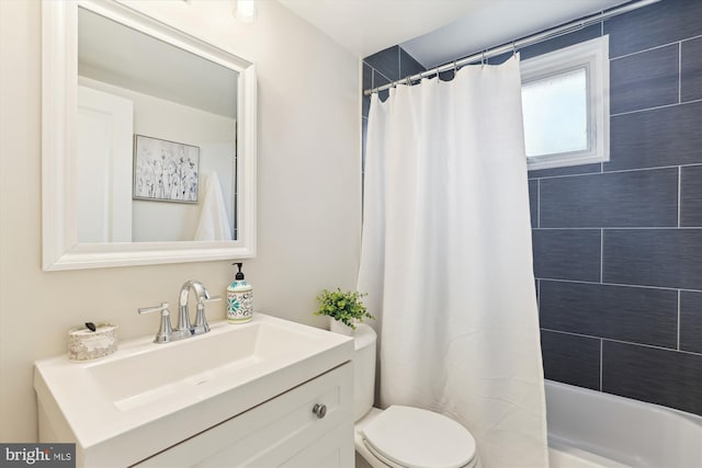 full bathroom with vanity, toilet, and shower / tub combo with curtain