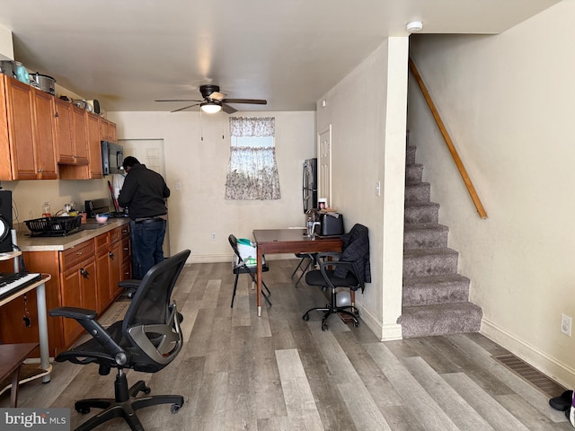 office area with ceiling fan and light hardwood / wood-style flooring