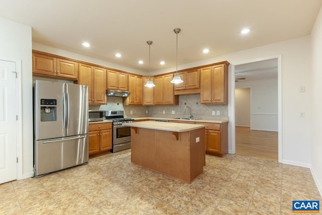 kitchen featuring pendant lighting, a center island, decorative backsplash, a kitchen bar, and stainless steel appliances