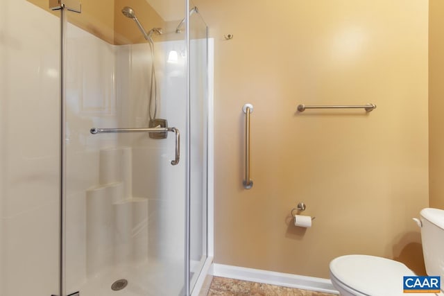 bathroom featuring walk in shower, tile patterned flooring, and toilet