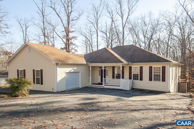 ranch-style home featuring a porch and a garage