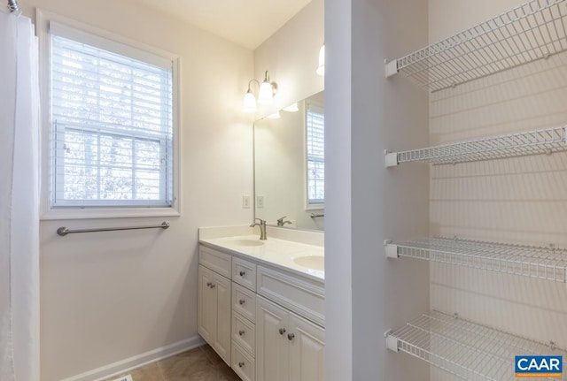 bathroom with tile patterned floors and vanity