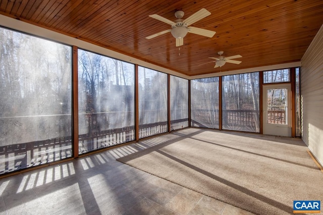 unfurnished sunroom featuring ceiling fan and wooden ceiling