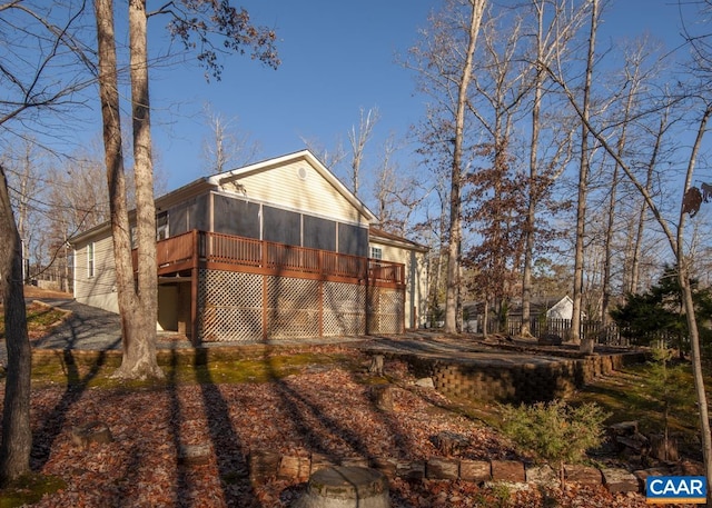 back of house featuring a sunroom