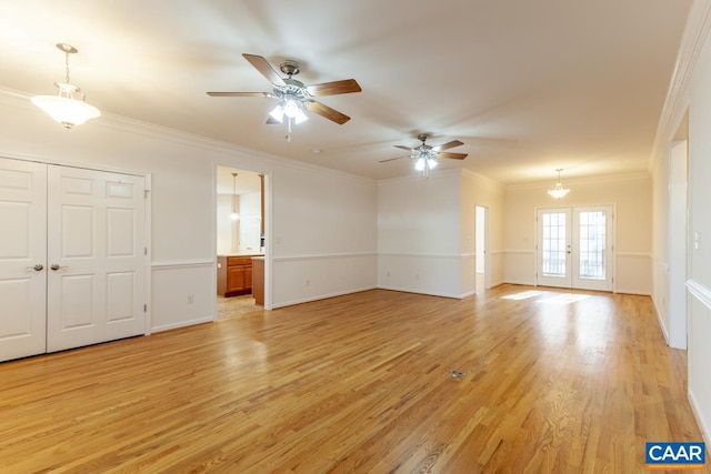 interior space featuring ceiling fan with notable chandelier, french doors, light wood-type flooring, and crown molding