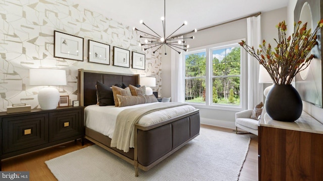 bedroom featuring a chandelier and wood-type flooring