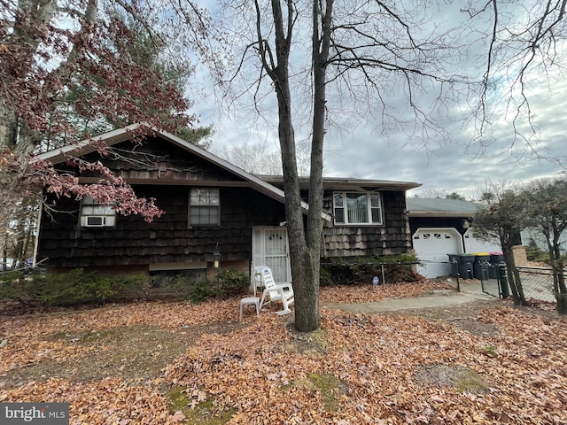 ranch-style house with cooling unit and a garage