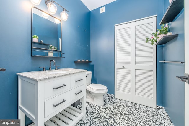 bathroom with vanity and toilet