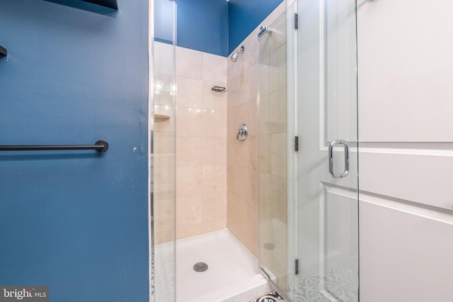 bathroom with a shower with door