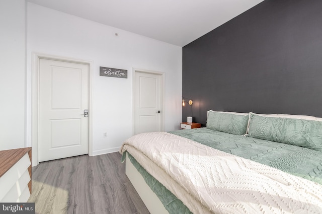 bedroom with wood-type flooring