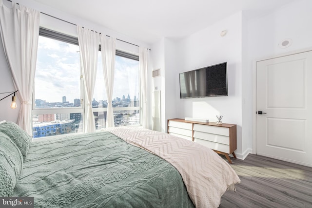 bedroom with hardwood / wood-style flooring