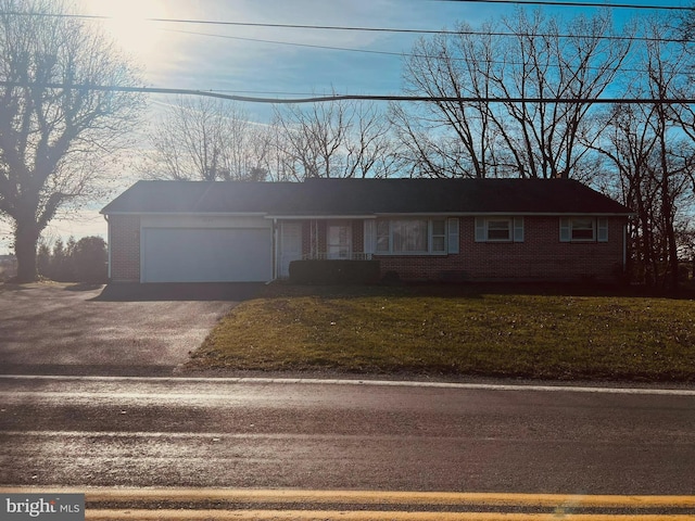 single story home with a front yard and a garage