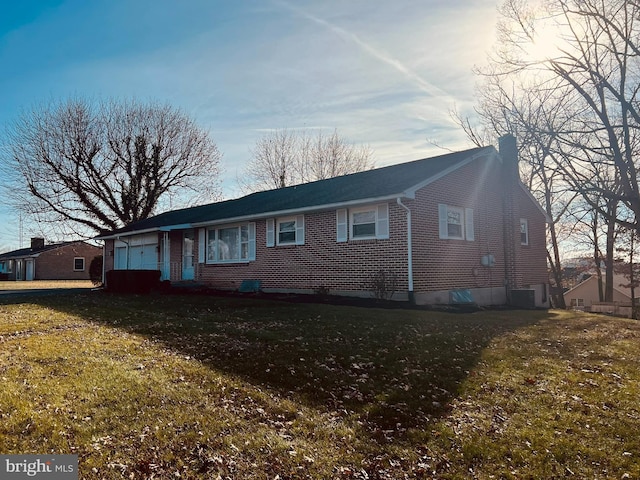 single story home featuring central air condition unit, a front lawn, and a garage