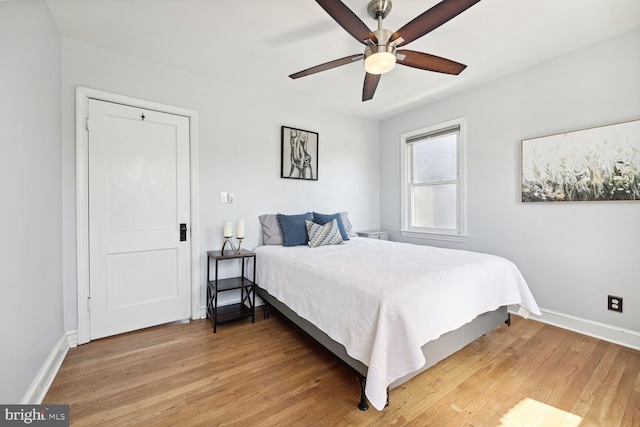 bedroom with hardwood / wood-style floors and ceiling fan