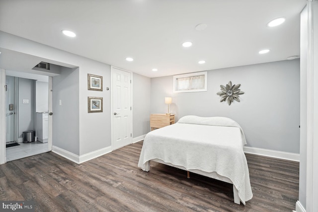 bedroom with dark wood-type flooring