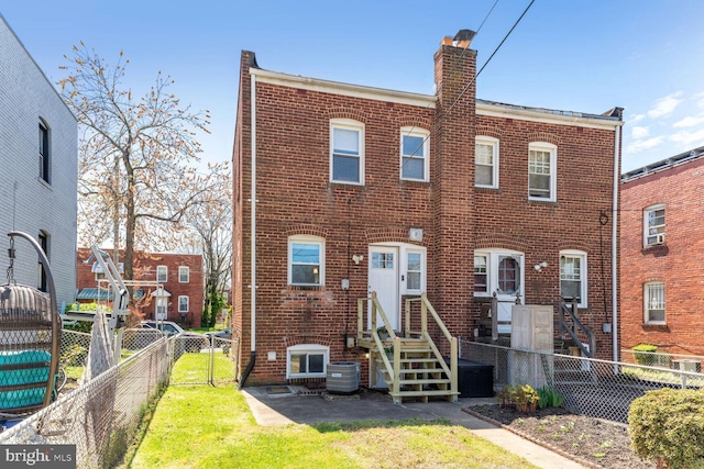 view of front of property with cooling unit and a front yard