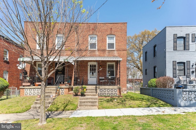 view of front of house with covered porch and a front yard