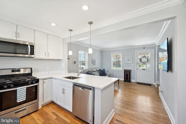 kitchen featuring white cabinets, sink, stainless steel appliances, and light hardwood / wood-style flooring