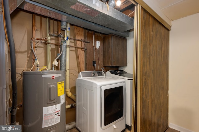 clothes washing area with washer and clothes dryer and electric water heater