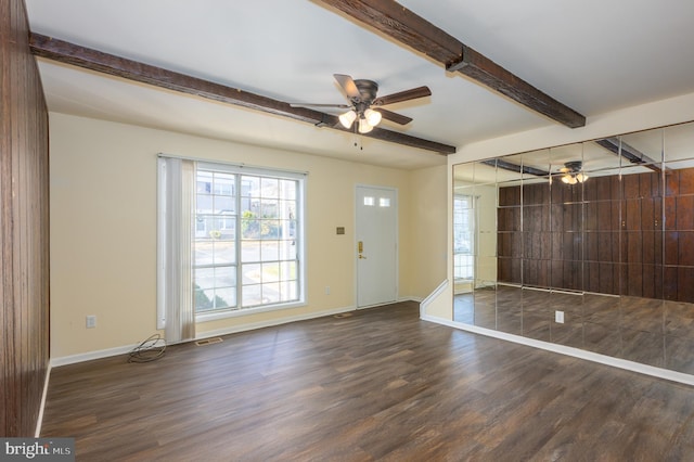 entryway featuring beam ceiling, ceiling fan, and dark wood-type flooring