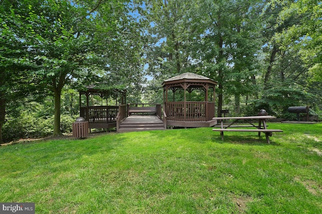 view of yard featuring a wooden deck and a gazebo